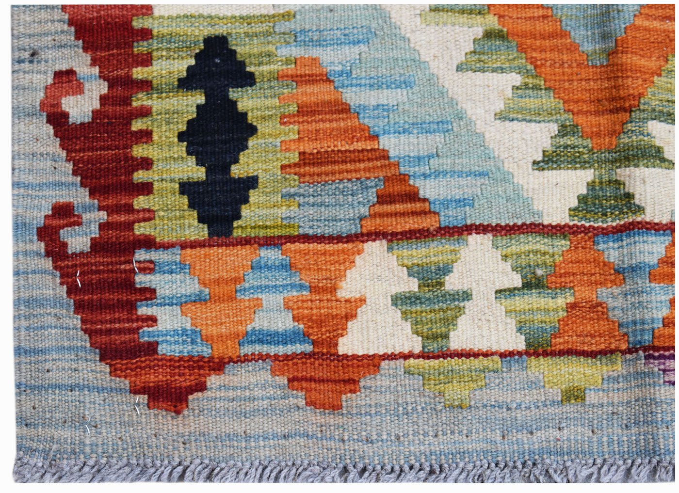 A handwoven Afghan Maimana kilim featuring a geometric pattern in vibrant orange, blue, and green.