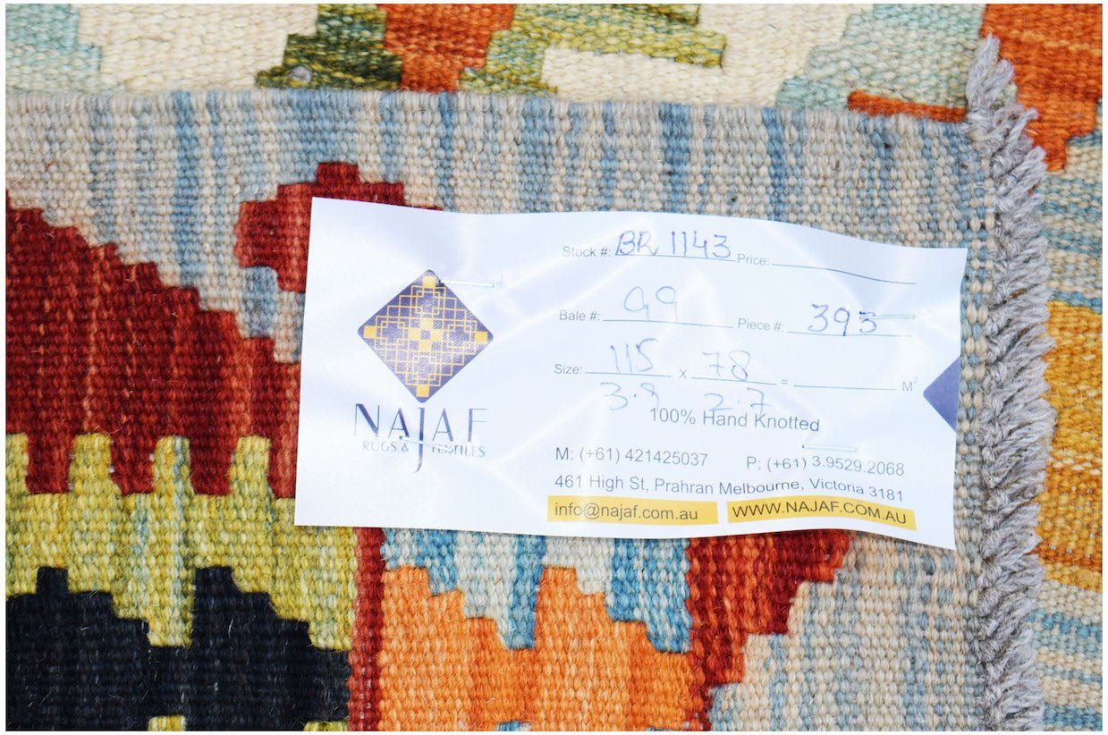 An Afghan Maimana kilim rug featuring a vibrant geometric pattern in red, yellow, and blue.