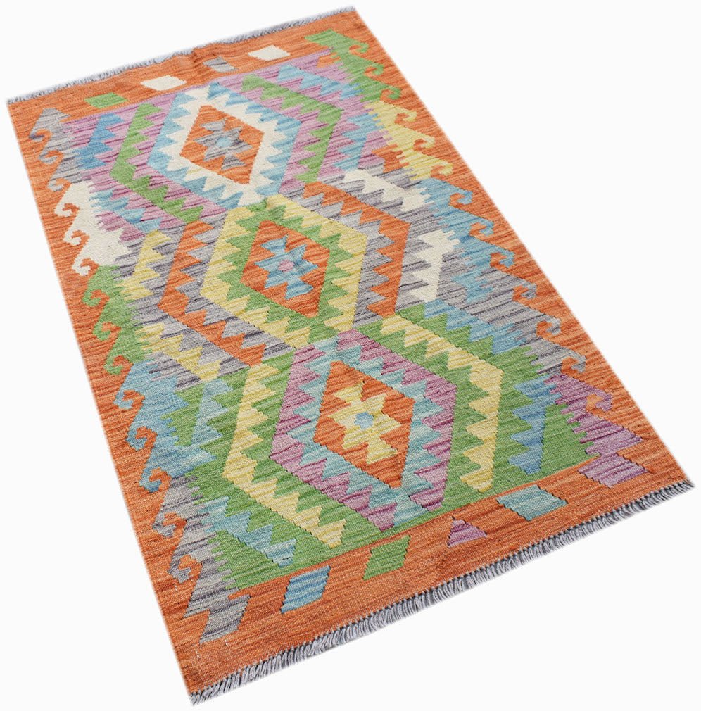 Handwoven Afghan Maimana kilim rug featuring a vibrant geometric diamond pattern in wool.