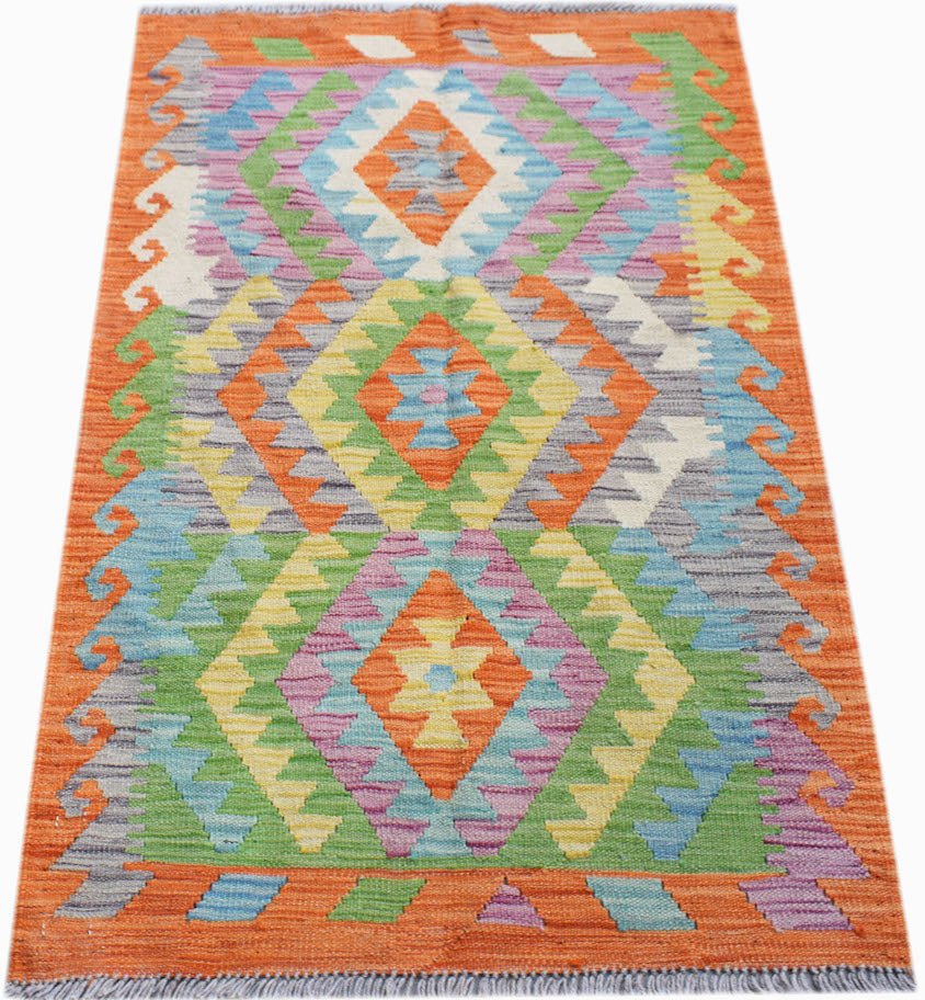 Handwoven Afghan Maimana kilim rug featuring a vibrant geometric diamond pattern in wool.