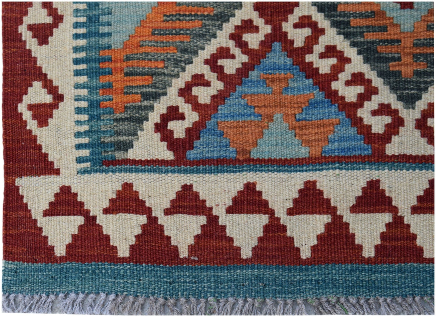 Handwoven Afghan Maimana kilim featuring a geometric pattern in red, blue, and orange wool.