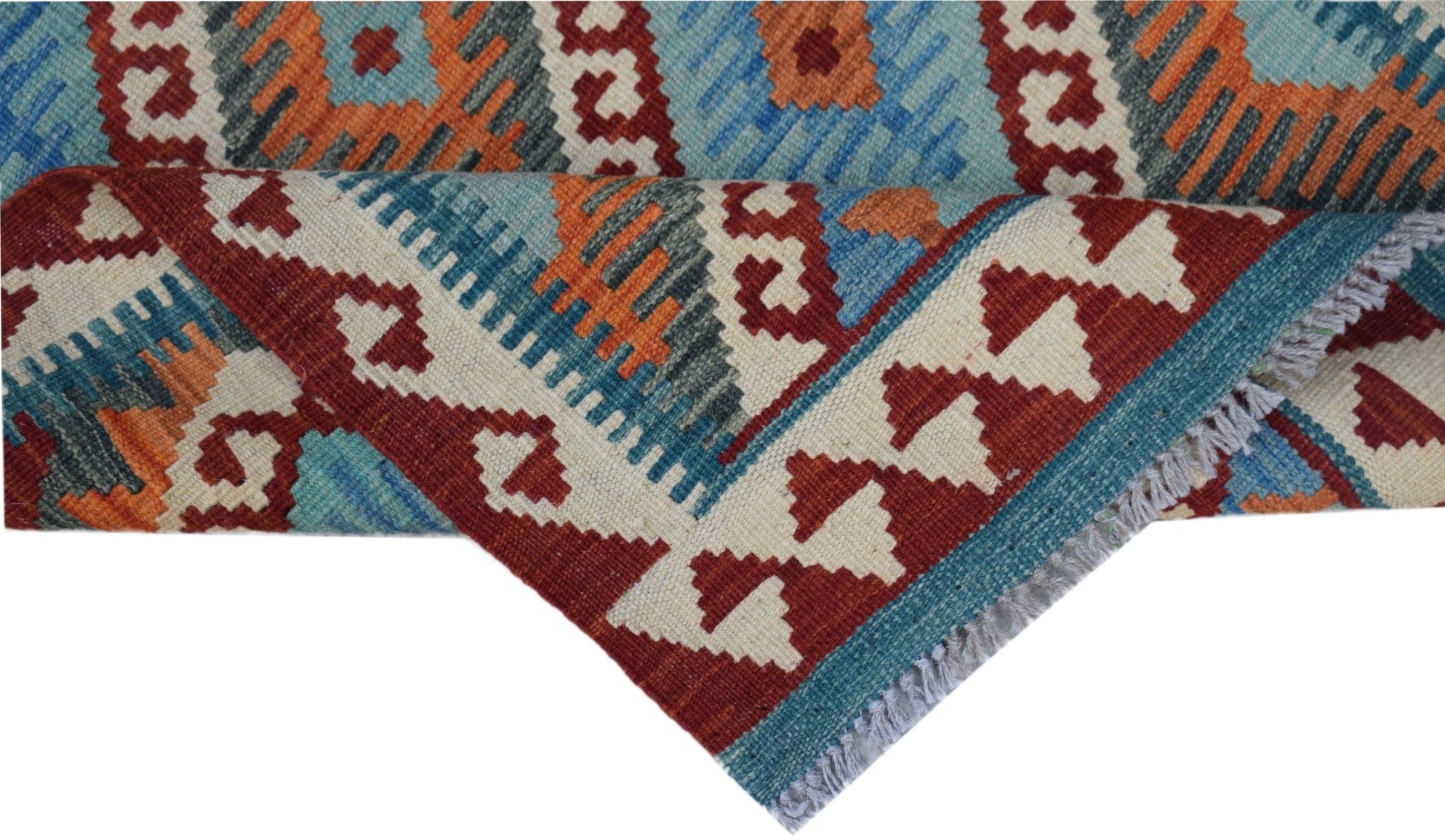 A handmade Afghan Maimana kilim rug featuring geometric patterns in red, blue, and orange wool.