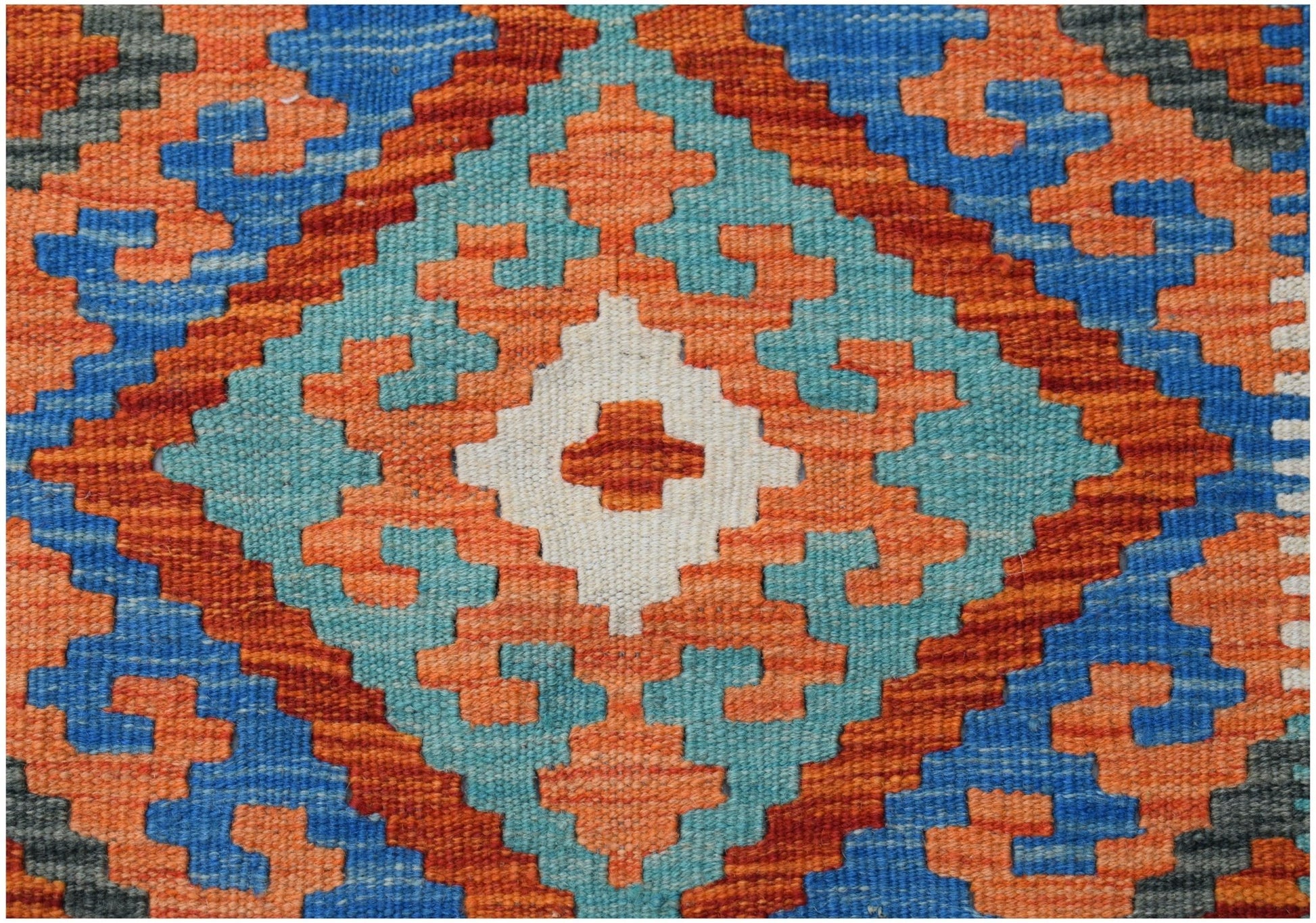 Handwoven Afghan Maimana kilim featuring a geometric diamond pattern in blue, orange, and white.