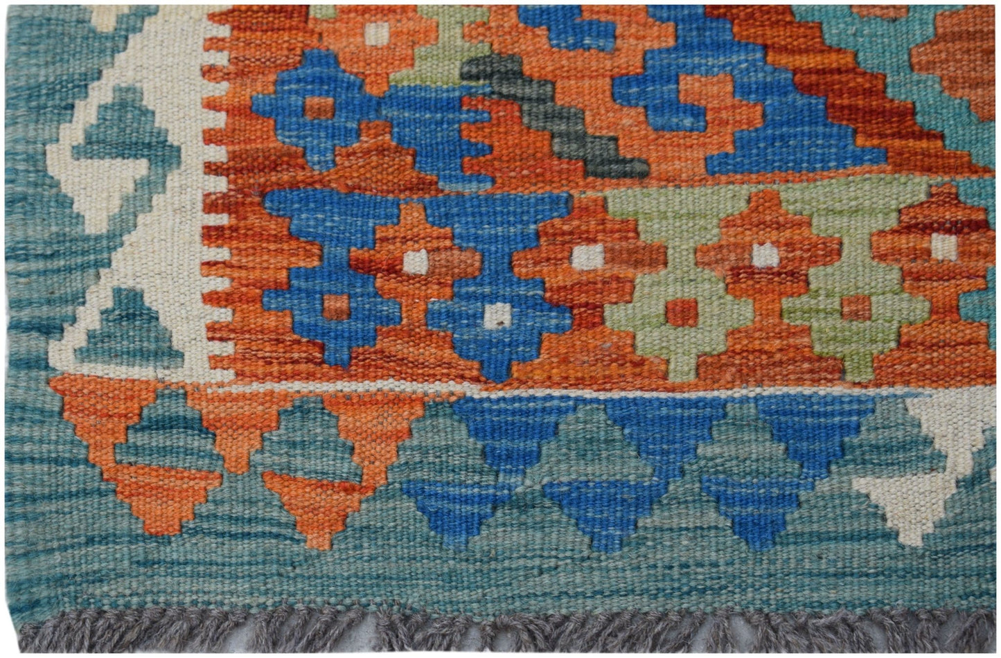 Handwoven Afghan Maimana kilim featuring a geometric pattern in blue, orange, and green wool.