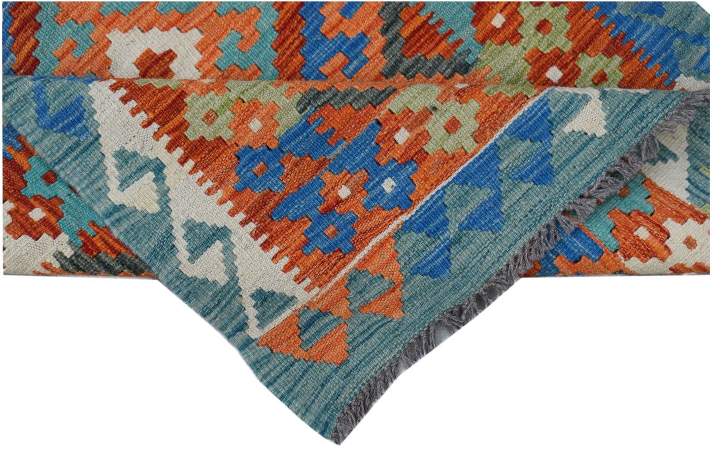 A handwoven Afghan Maimana kilim rug featuring a geometric pattern in orange, blue, and green.
