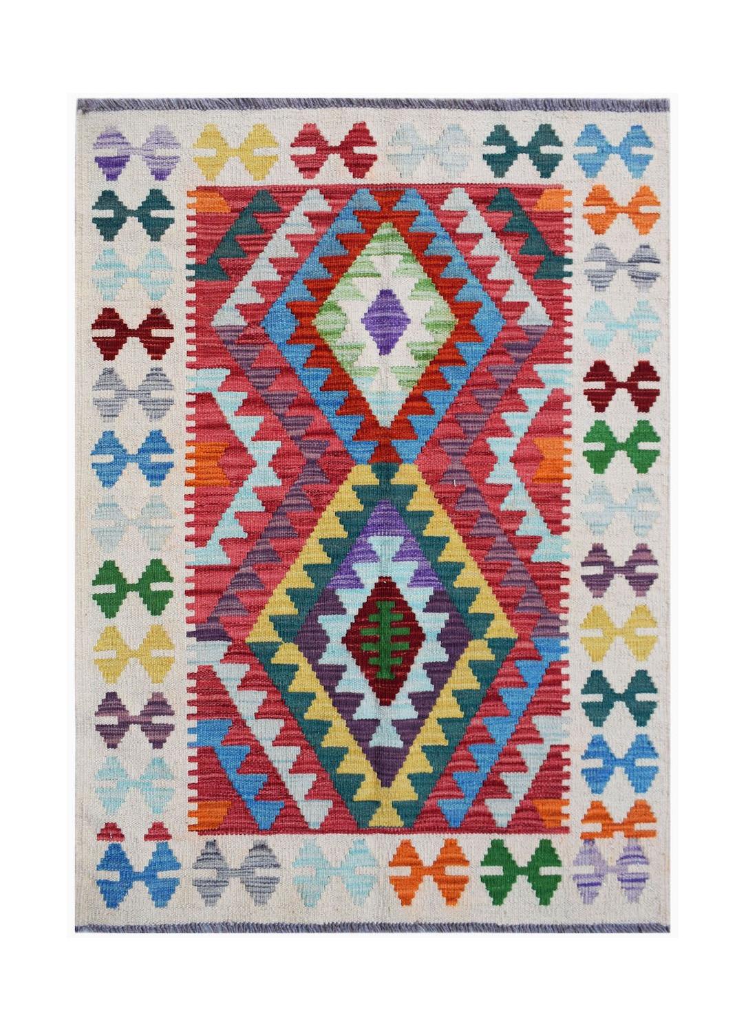 Handwoven Afghan Maimana kilim rug featuring a vibrant geometric diamond pattern in wool.