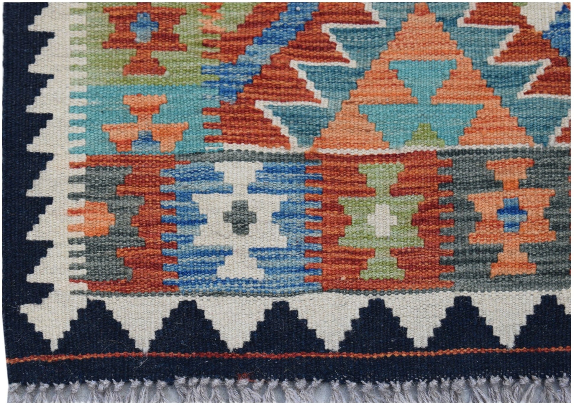 Handwoven Afghan Maimana kilim rug featuring a colorful geometric pattern and fringed edges.