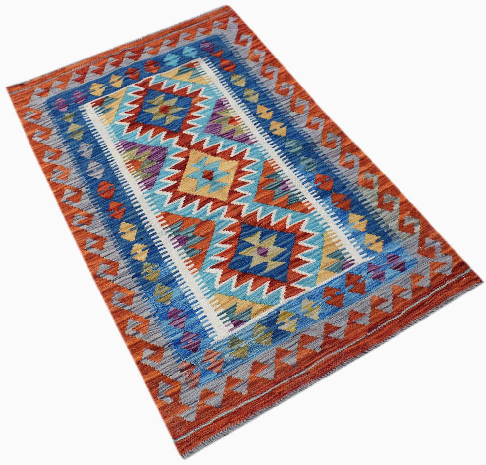 Handwoven Afghan Maimana kilim rug featuring a geometric pattern in blue, orange, and yellow.