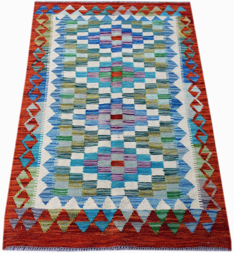 Handwoven Afghan Maimana kilim rug featuring a geometric checkered pattern in blue and red tones.