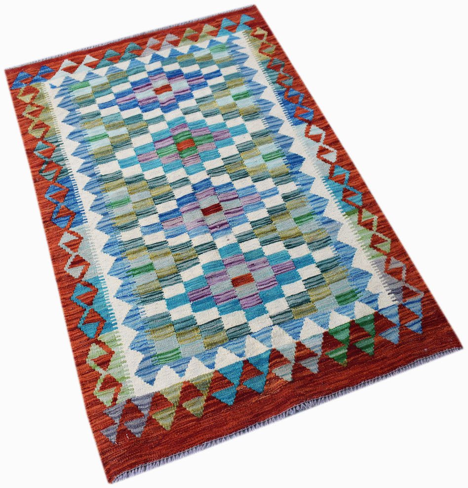 Handwoven Afghan Maimana kilim rug featuring a geometric checkered pattern in blue and green tones.