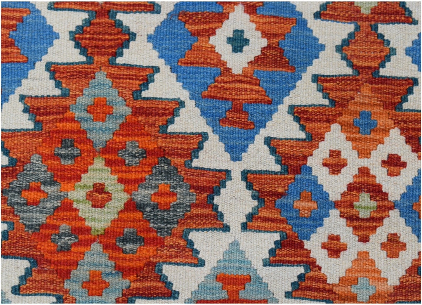 Handwoven Afghan Maimana kilim featuring a vibrant geometric pattern in orange, blue, and grey.
