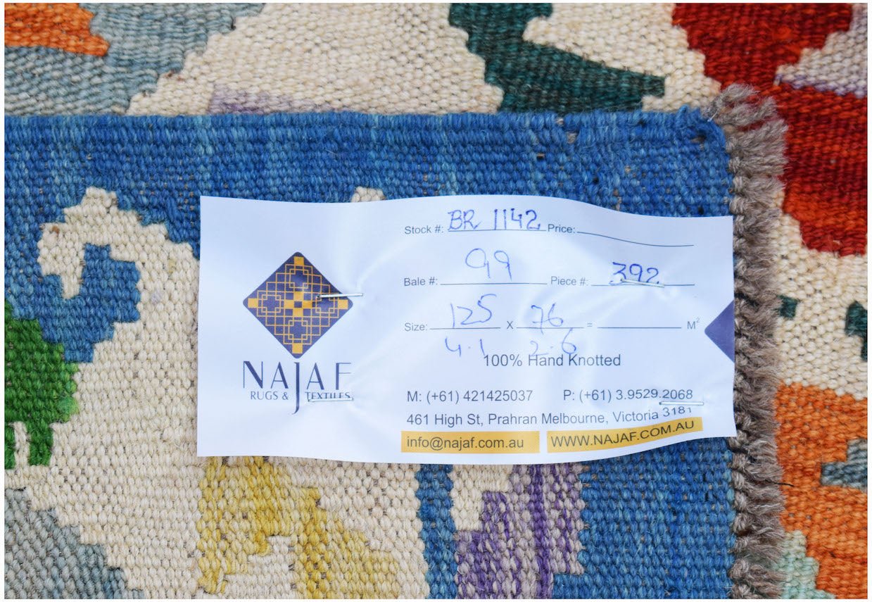 A handwoven Afghan Maimana Kilim featuring a vibrant geometric pattern in wool.