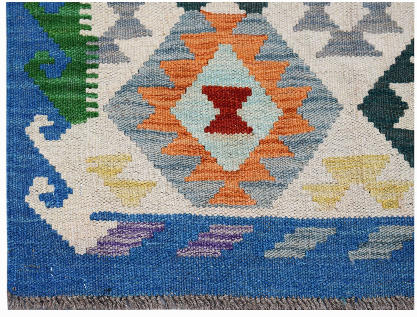 Handwoven Afghan Maimana kilim featuring a geometric diamond pattern in vibrant wool colors.