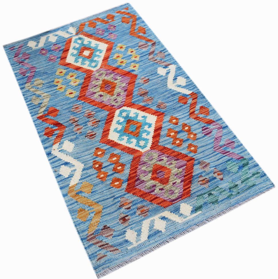 Handwoven Afghan Maimana kilim rug featuring geometric patterns in blue, orange, and purple.