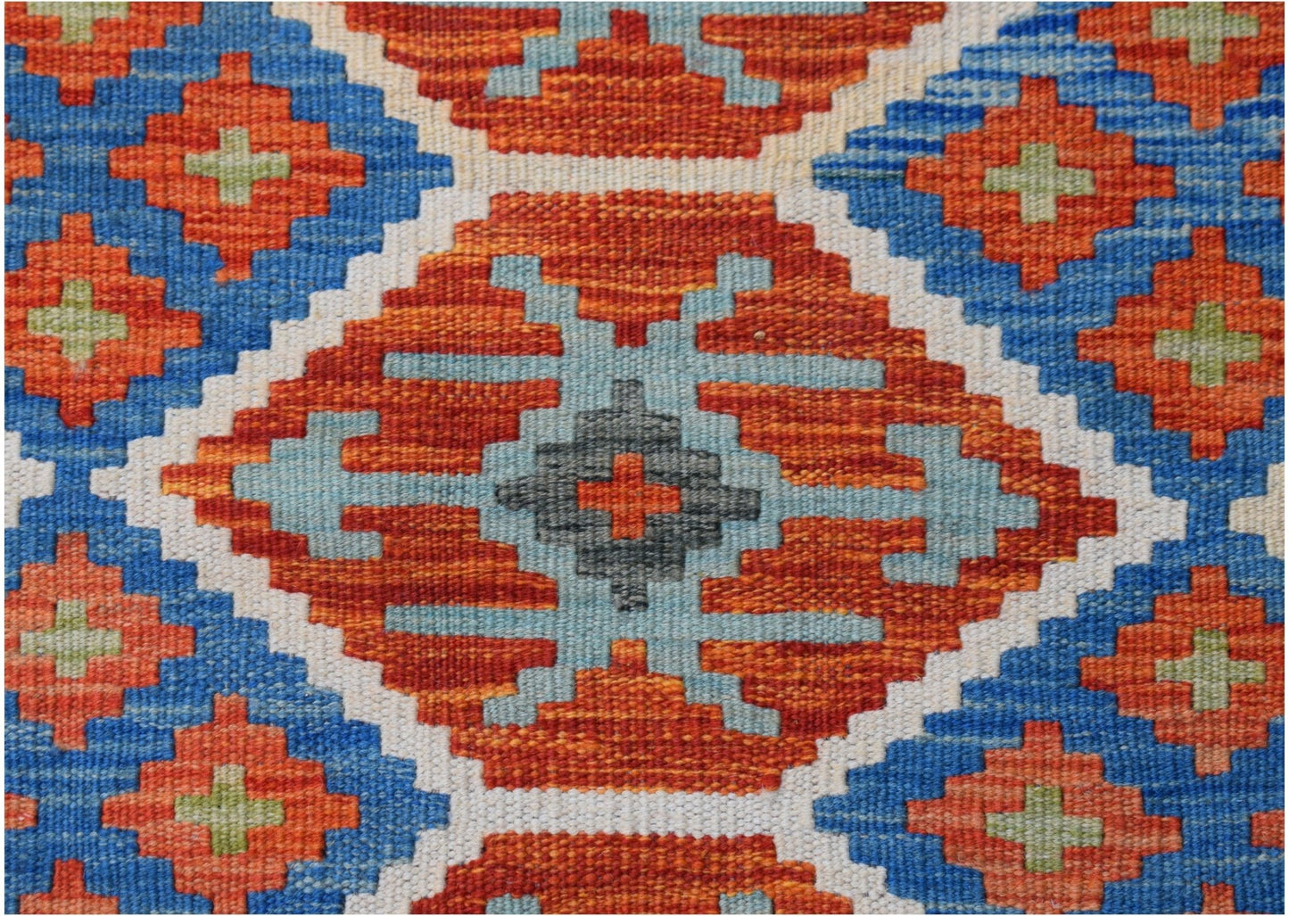 Handwoven Afghan Maimana kilim featuring a geometric pattern in orange, blue, and grey wool.