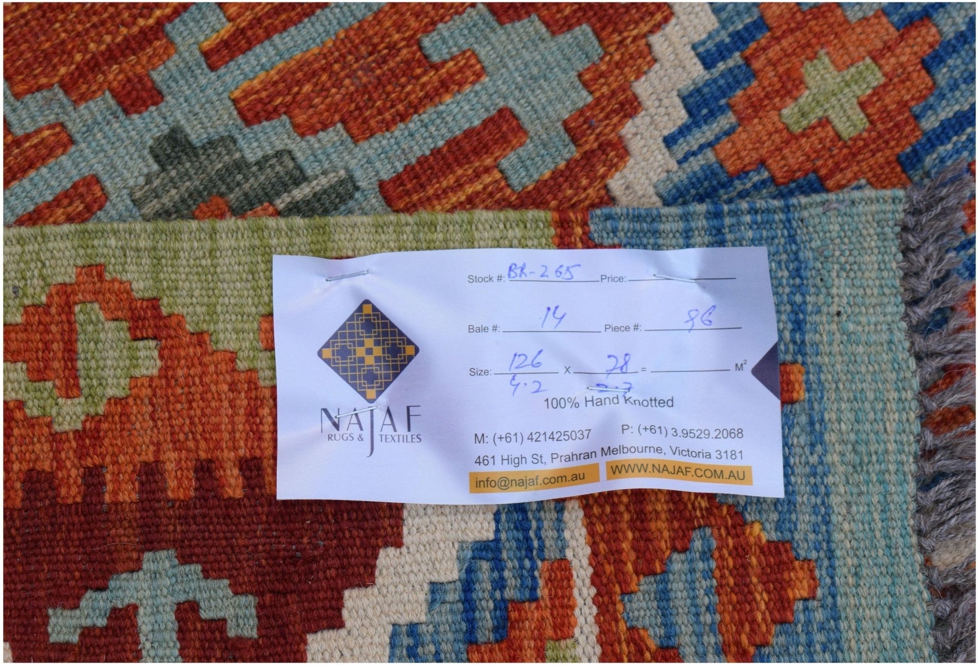 A handwoven Afghan Maimana kilim featuring a vibrant geometric pattern in wool.