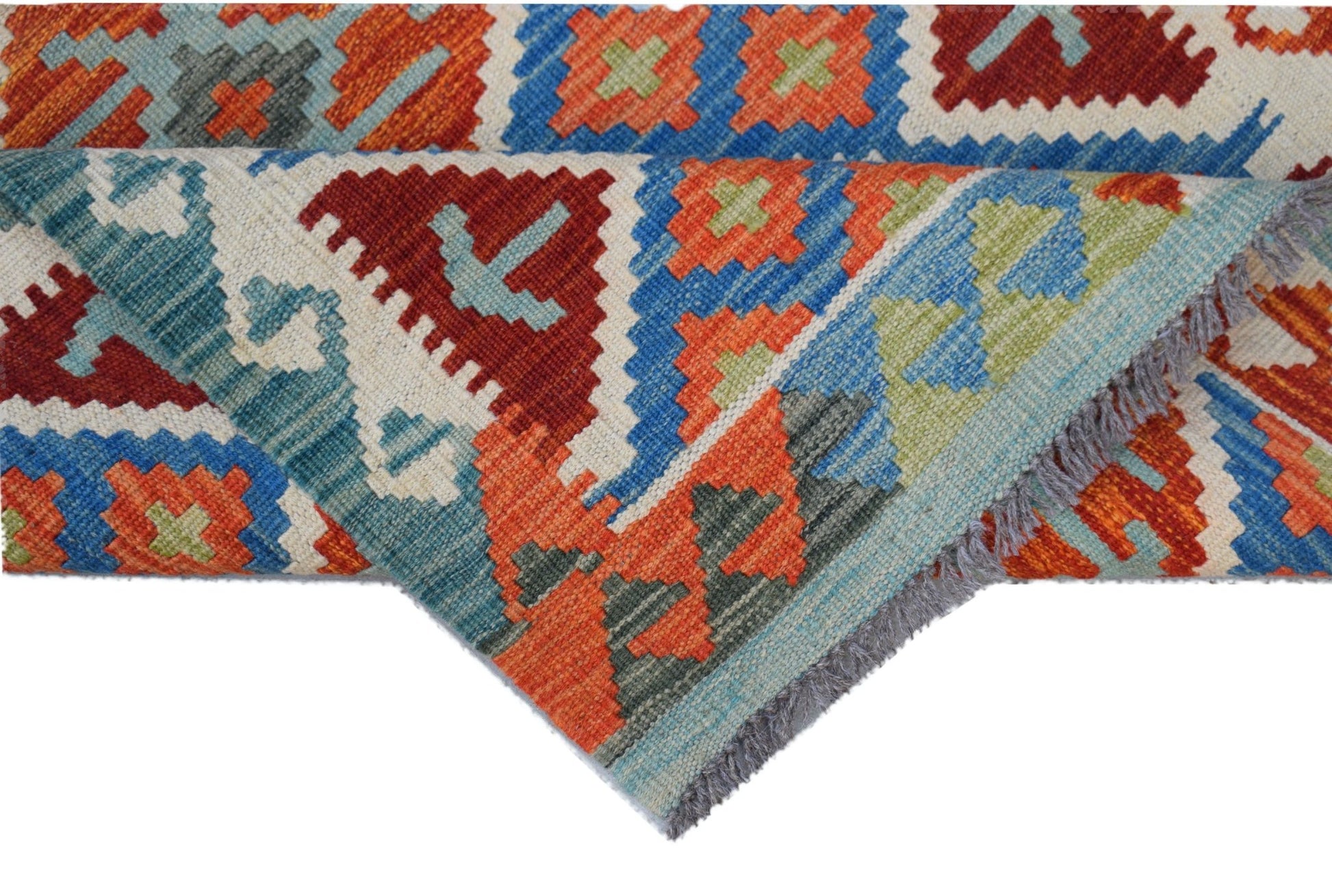 A handwoven Afghan Maimana kilim rug featuring a geometric pattern in vibrant red, blue, and green.