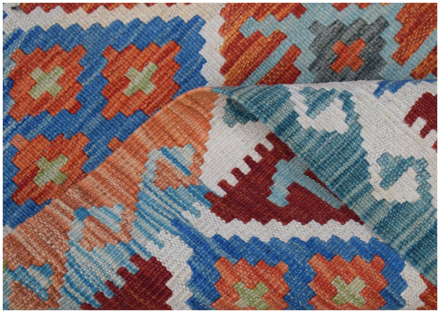 A handmade Afghan Maimana kilim rug featuring a geometric pattern in vibrant orange, blue, and red.