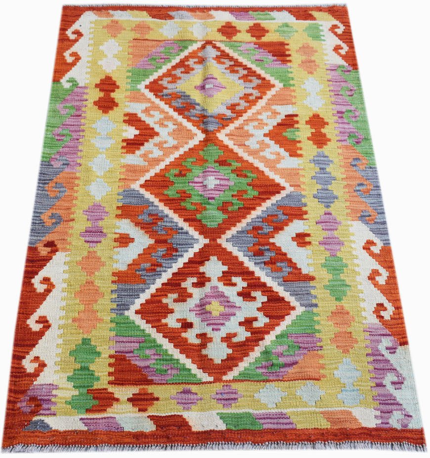 Handwoven Afghan Maimana kilim rug featuring a vibrant geometric diamond pattern in wool.