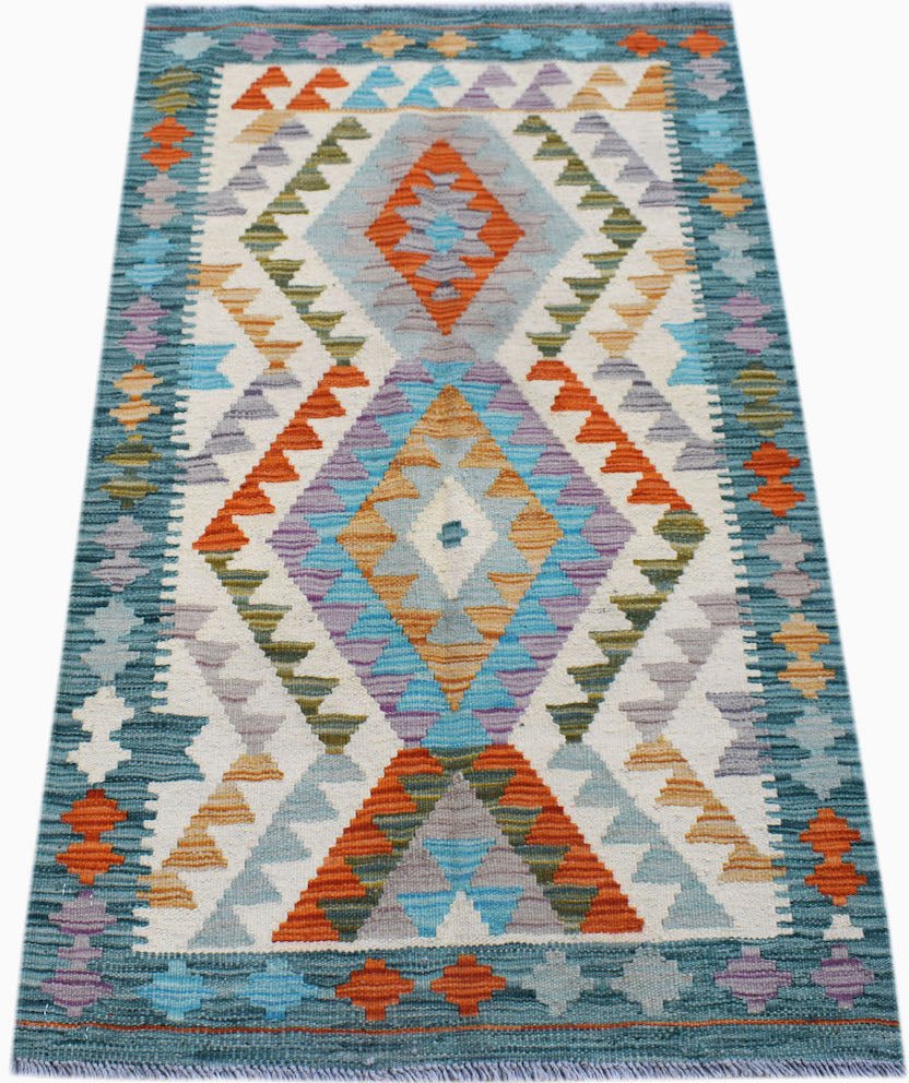 Handwoven Afghan Maimana kilim rug featuring a geometric diamond pattern in vibrant colors.