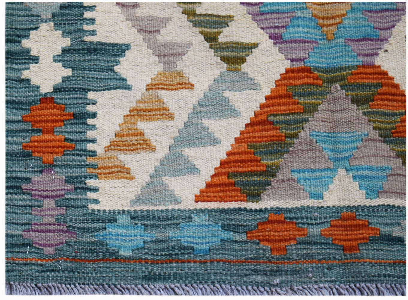 Handwoven Afghan Maimana kilim featuring a geometric pattern in vibrant multicolored wool.