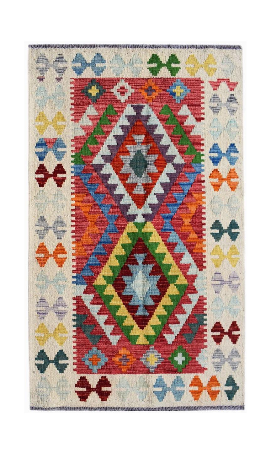 Handwoven Afghan Maimana kilim rug featuring a vibrant geometric pattern in wool.