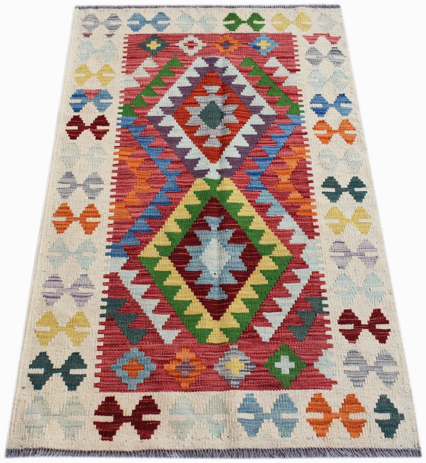 Handwoven Afghan Maimana kilim rug featuring a vibrant geometric diamond pattern in wool.