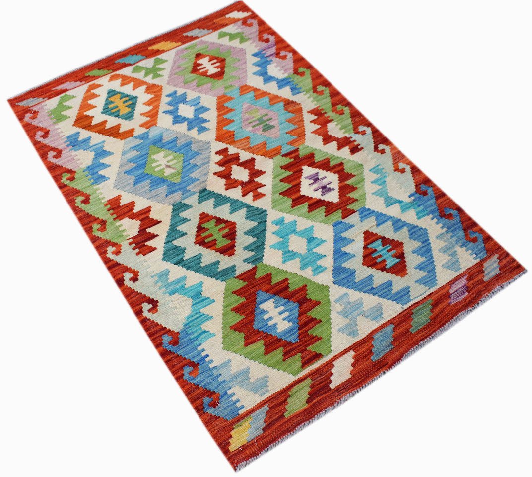 Handwoven Afghan Maimana kilim rug featuring a colorful geometric diamond pattern on a cream base.