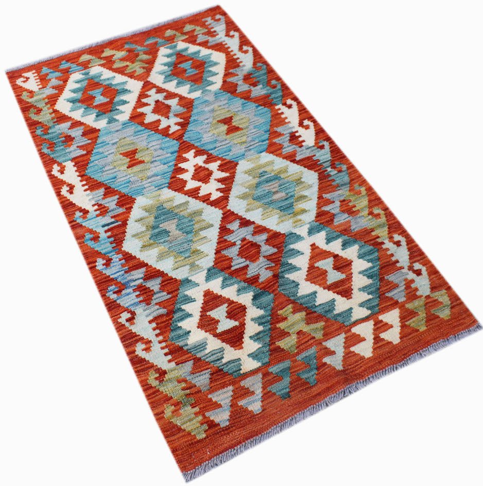 Handwoven Afghan Maimana kilim rug featuring a geometric diamond pattern in red, blue, and green.