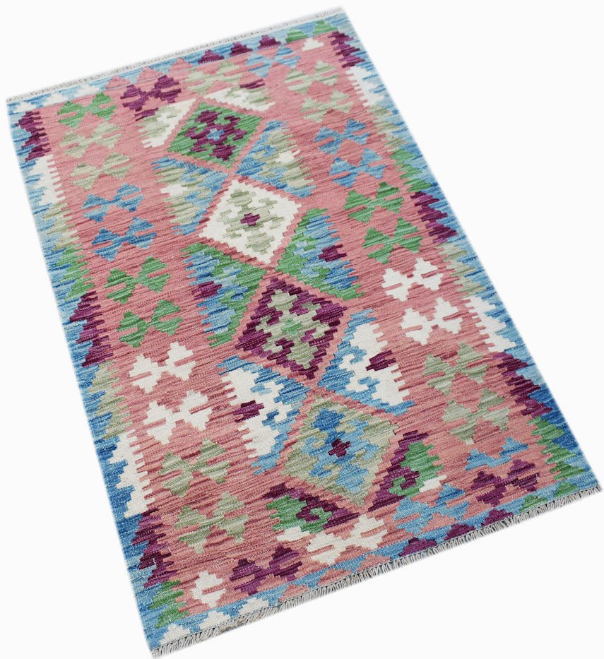 Handwoven Afghan Maimana kilim rug featuring a geometric diamond pattern in pink, blue, and green.