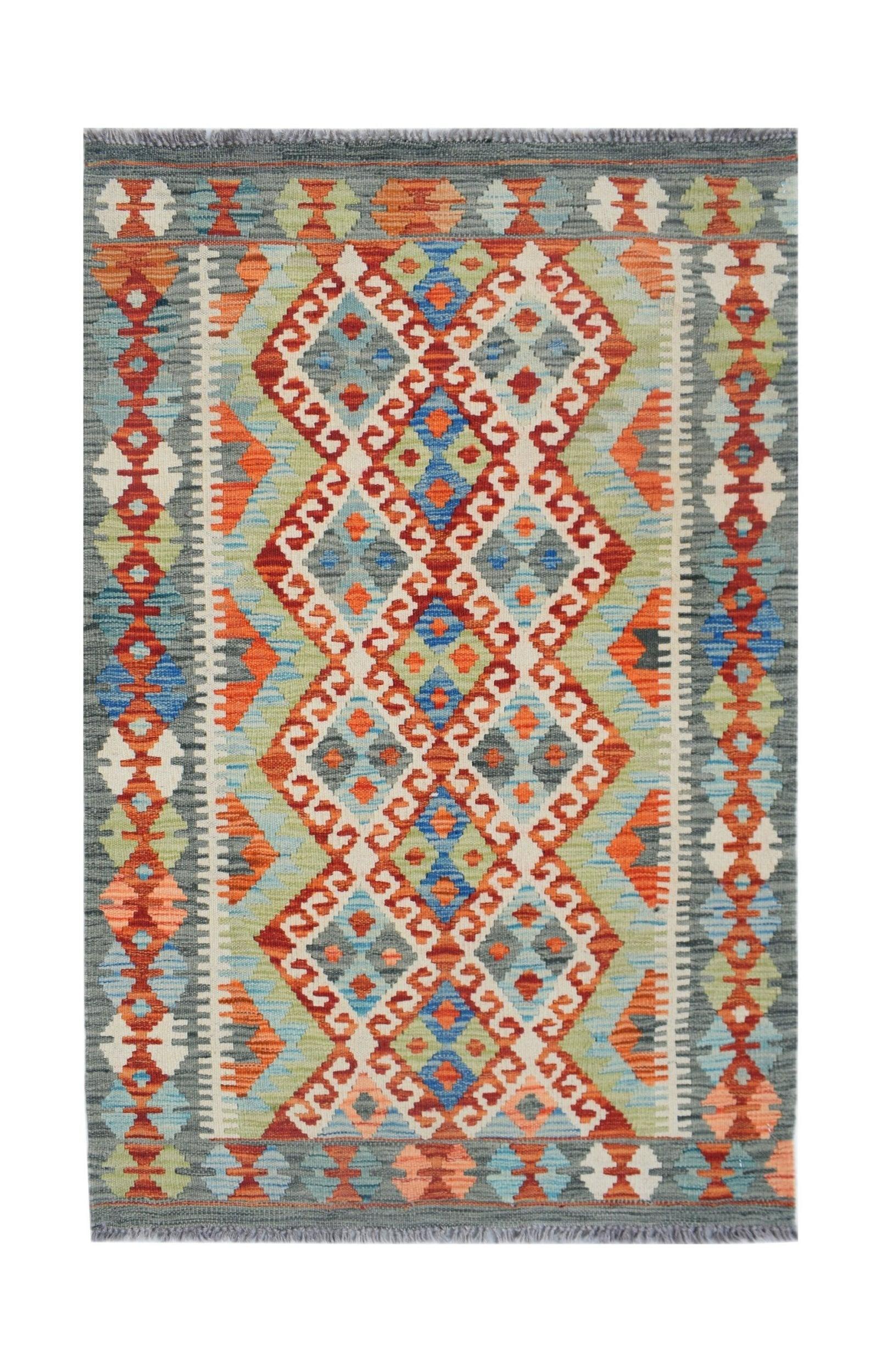 Handwoven Afghan Maimana kilim rug featuring a colorful geometric diamond pattern on a grey base.