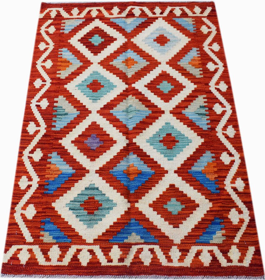 Handwoven Afghan Maimana kilim rug featuring a geometric diamond pattern in red, blue, and white.