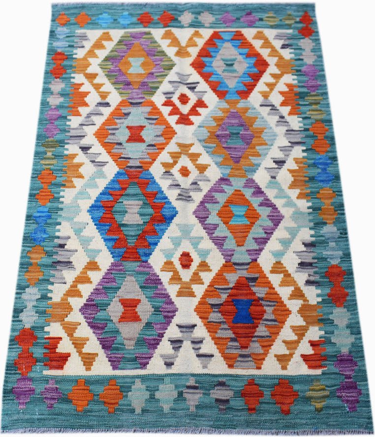 Handwoven Afghan Maimana kilim rug featuring a colorful geometric diamond pattern on a cream base.