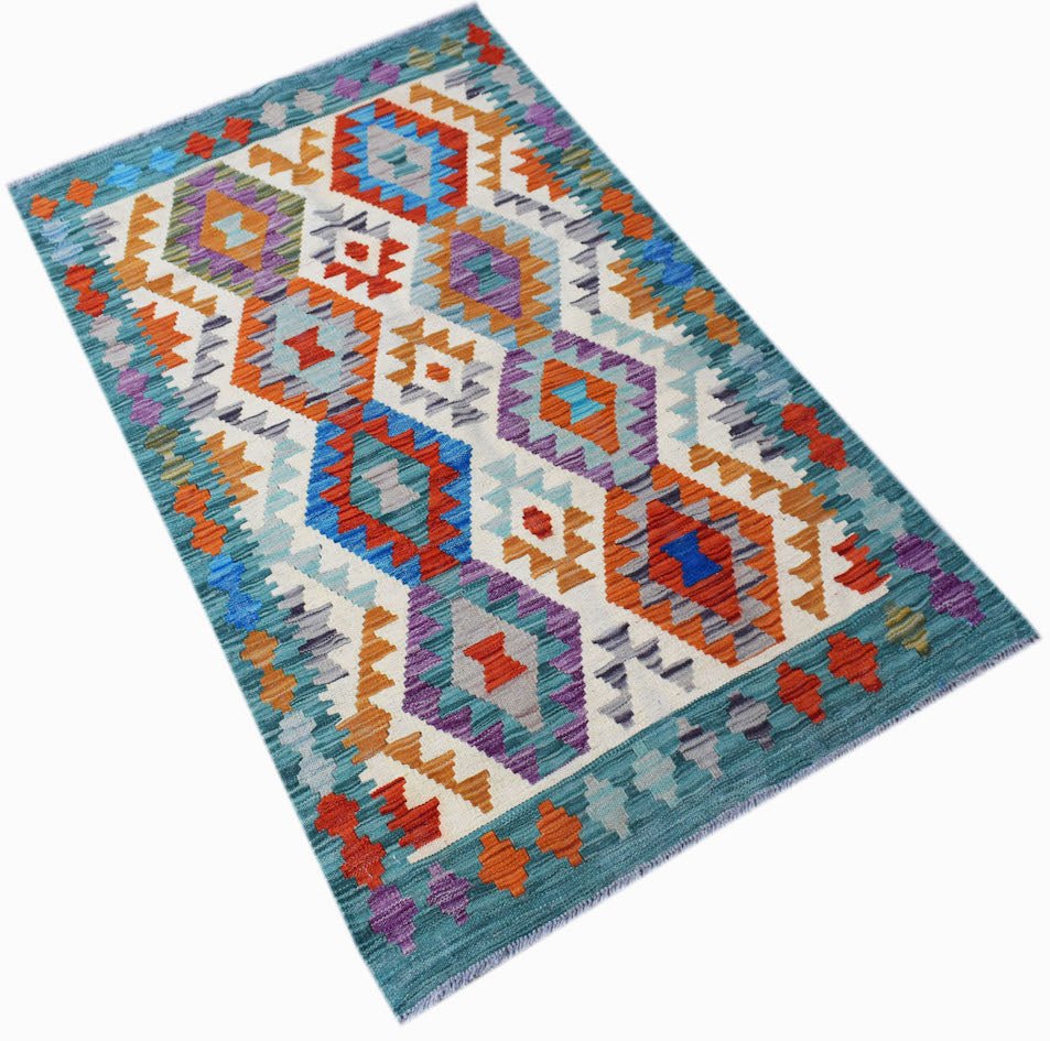 Handwoven Afghan Maimana kilim rug featuring a colorful geometric diamond pattern on a teal border.