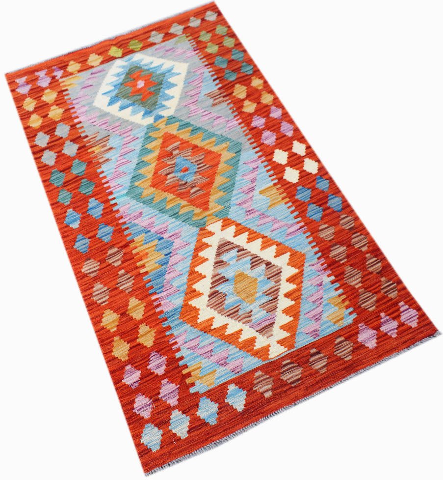 Handwoven Afghan Maimana kilim rug featuring a geometric diamond pattern in vibrant colors.