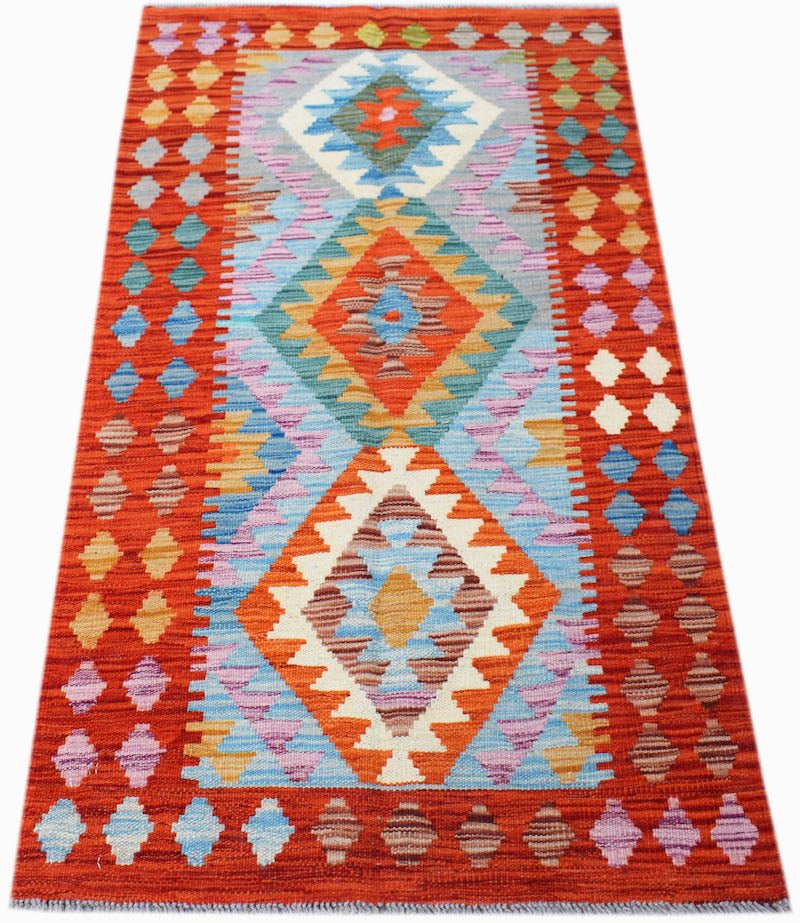 Handwoven Afghan Maimana kilim rug featuring a vibrant geometric diamond pattern in wool.