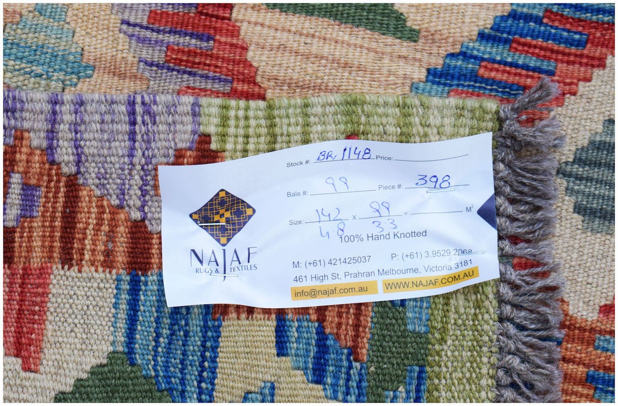 A handwoven Afghan Maimana kilim featuring a vibrant geometric pattern in wool.