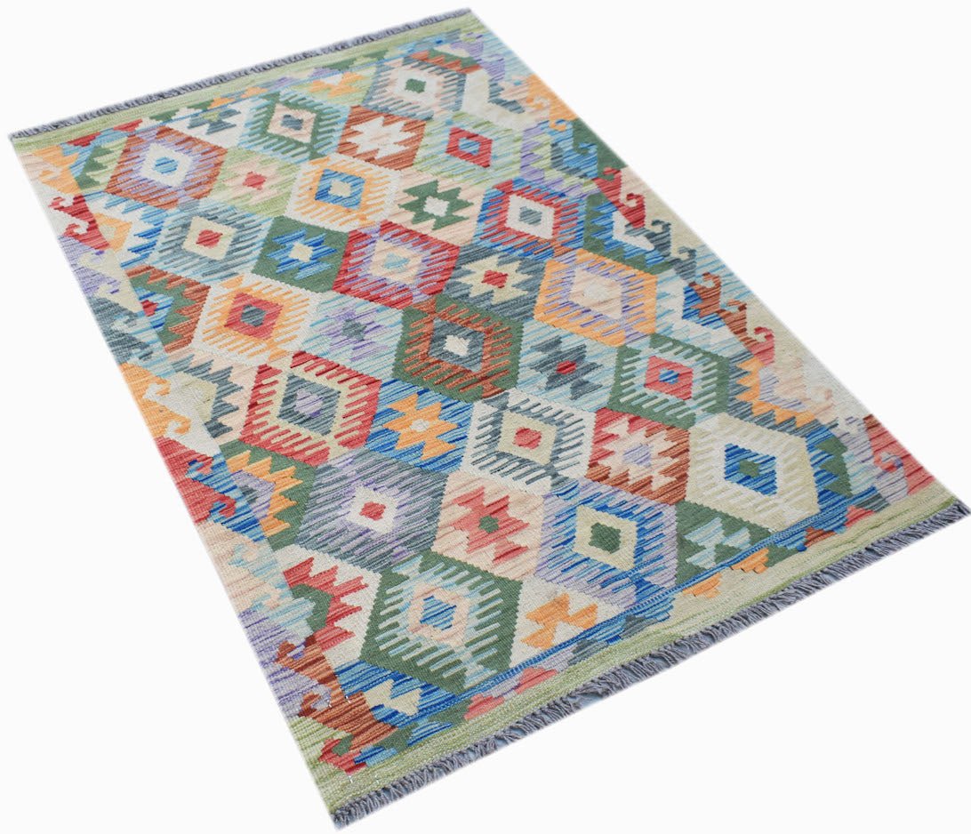 Handwoven Afghan Maimana kilim rug featuring a colorful geometric diamond pattern in wool.