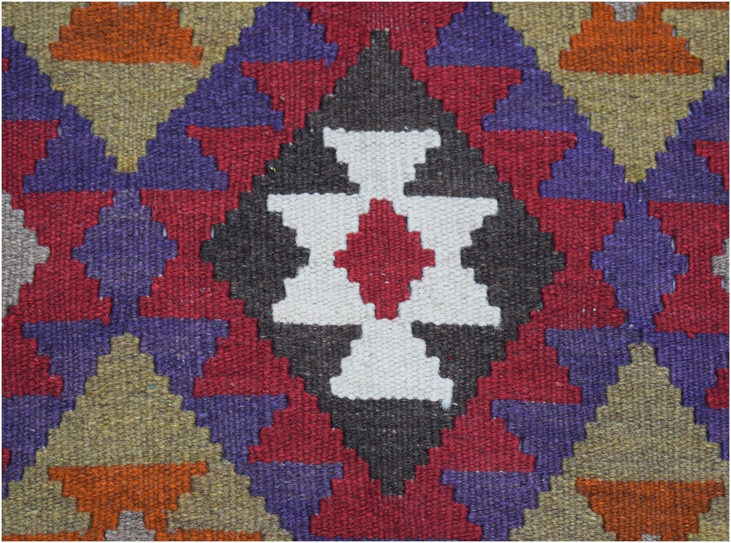Handwoven Afghan Maimana kilim featuring a geometric pattern in red, purple, white, and orange.