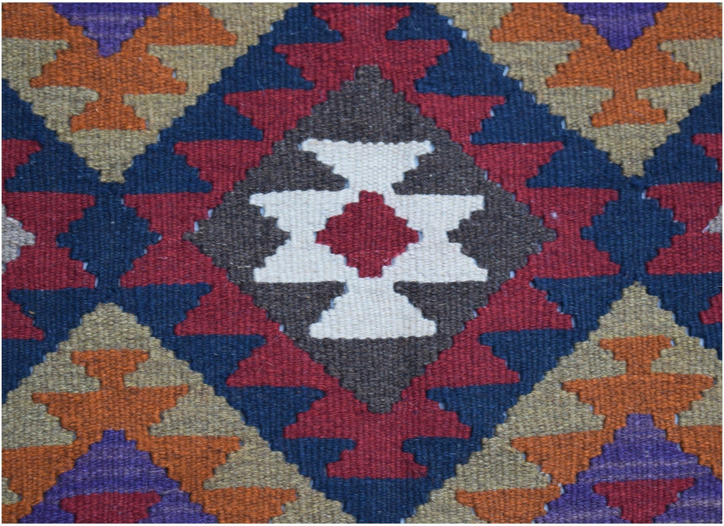 Handwoven Afghan Maimana kilim featuring a geometric diamond pattern in rich, multicolored wool.