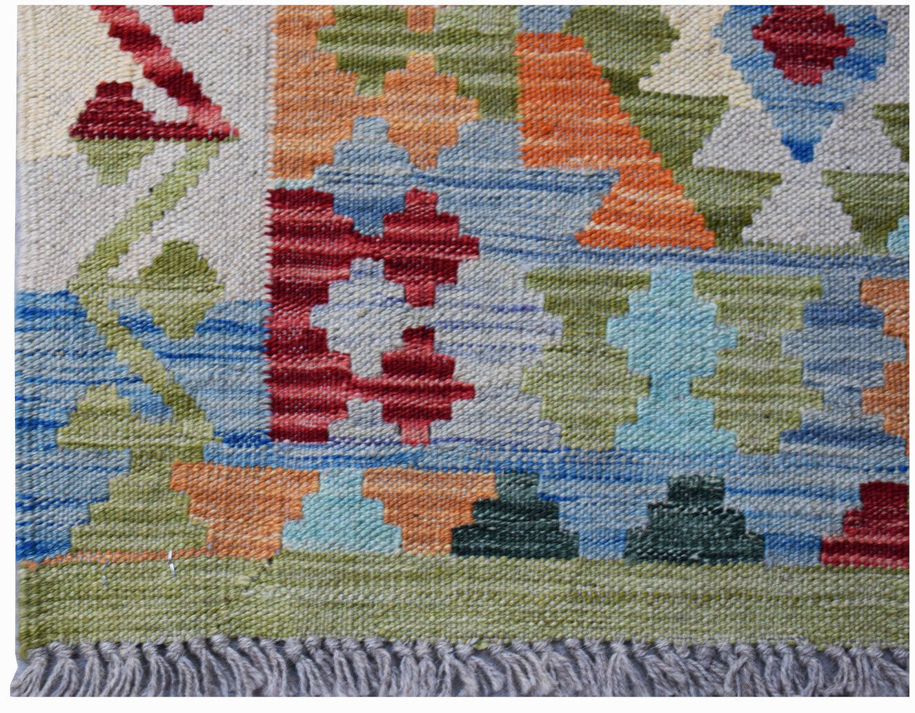 A handwoven Afghan Maimana kilim featuring a colorful geometric pattern and a flat wool texture.