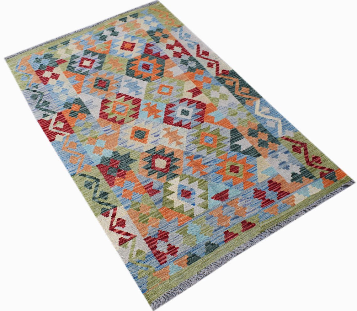 Handmade Afghan Maimana kilim rug featuring a colorful geometric pattern in wool.