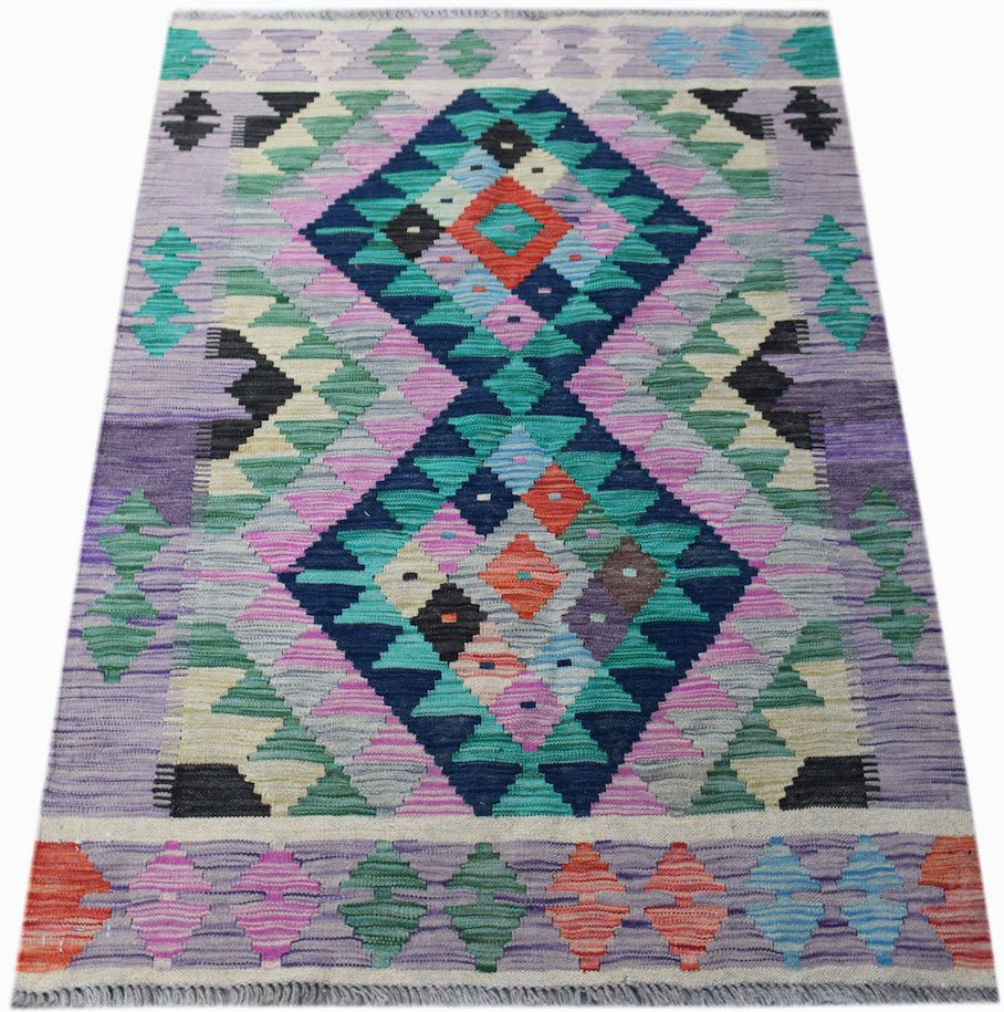 Handwoven Afghan Maimana kilim rug featuring a colorful geometric diamond pattern on a purple base.