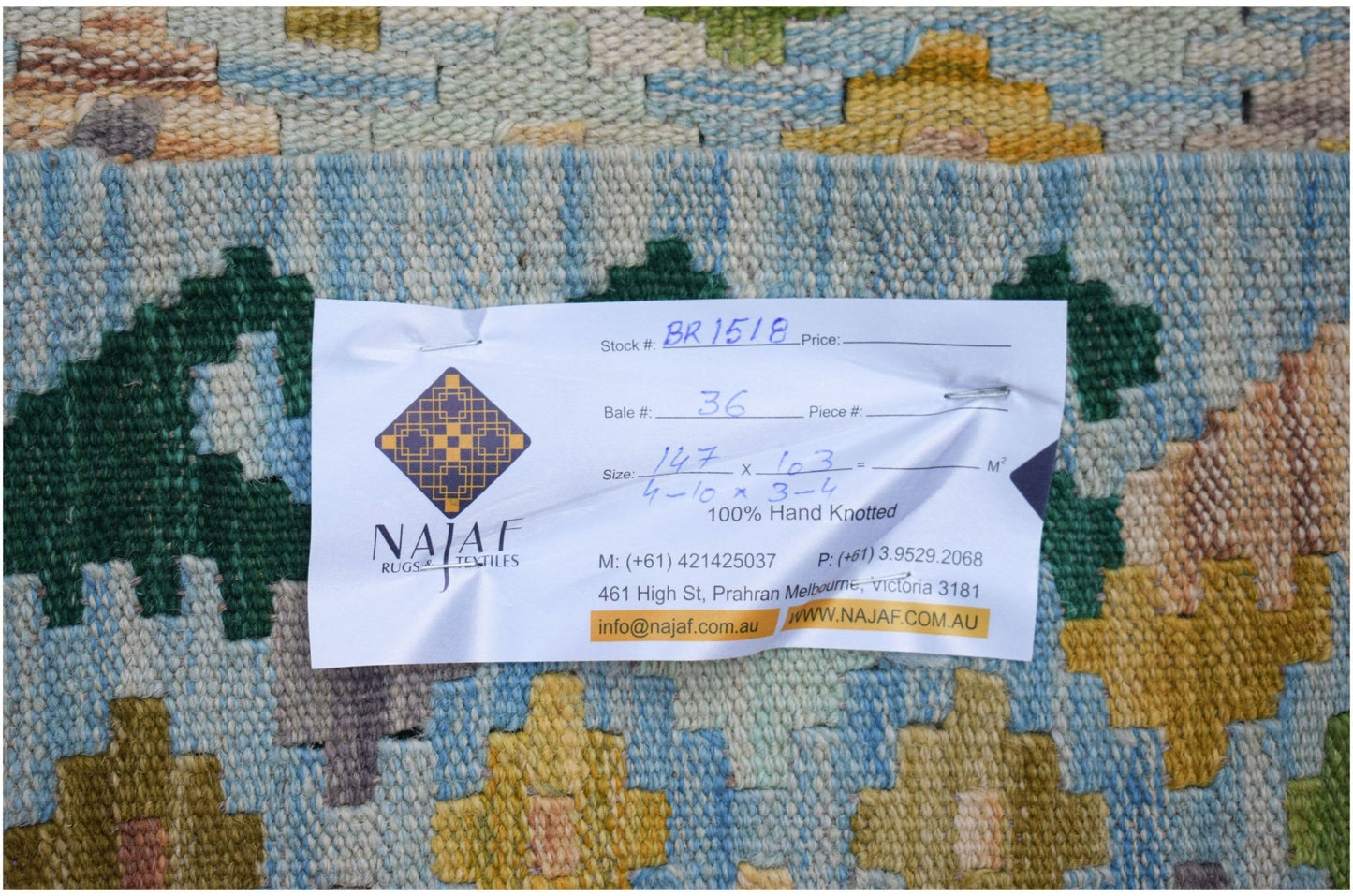 A flatwoven Afghan Maimana kilim featuring a geometric pattern in blue, green, and yellow tones.