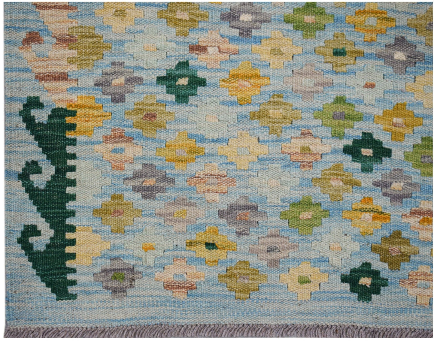 Handwoven Afghan Maimana kilim featuring a light blue background with colorful geometric motifs.