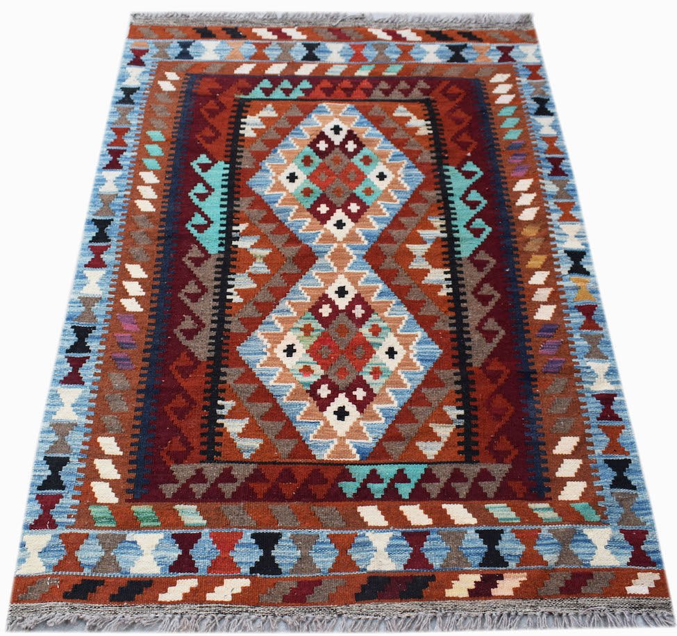 Handwoven Afghan Maimana kilim rug featuring a geometric diamond pattern in rich earthy tones.