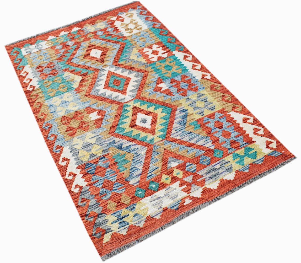 Handwoven Afghan Maimana kilim rug featuring a geometric pattern in red, blue, and cream tones.