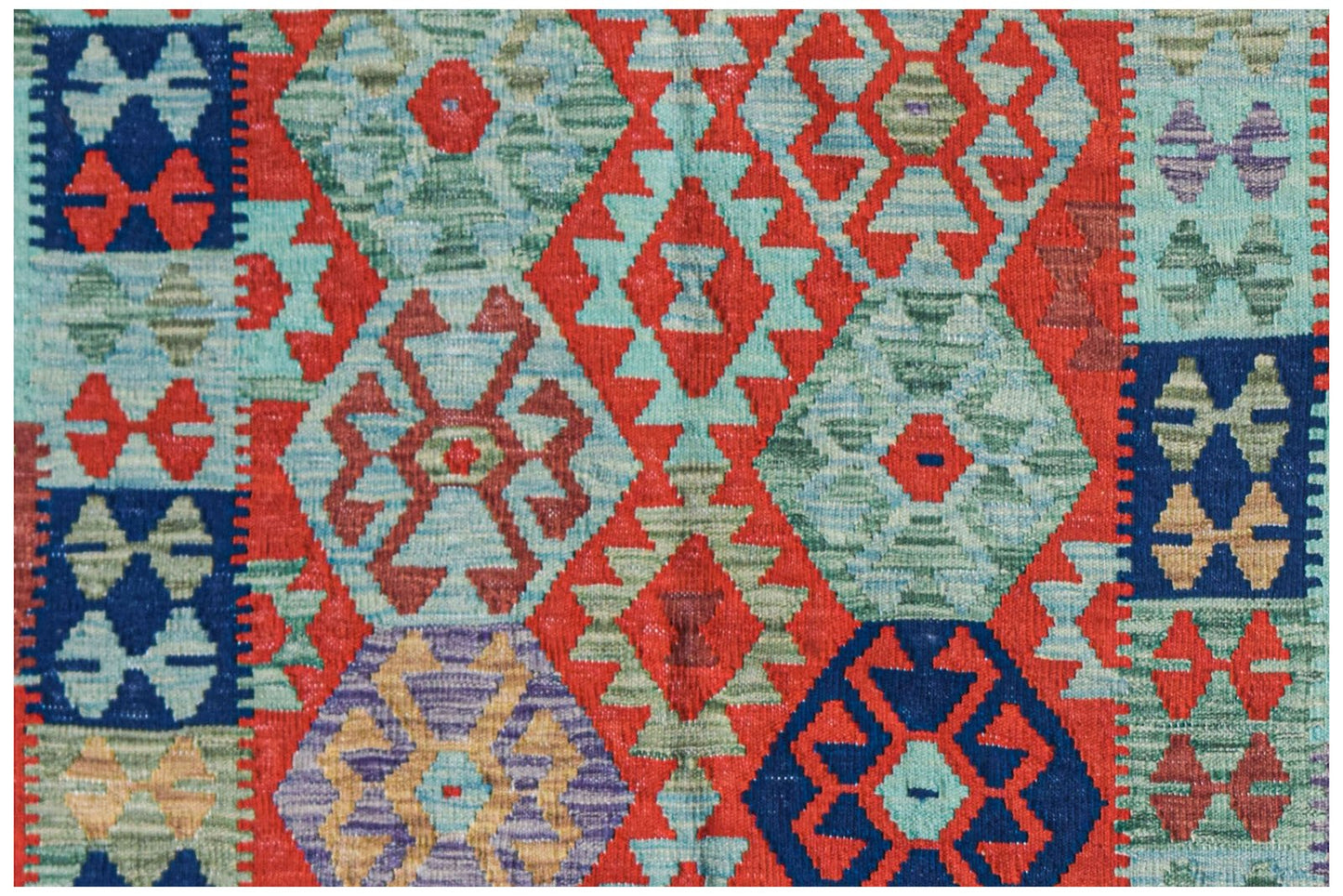 Handwoven Afghan Maimana kilim rug featuring a vibrant geometric pattern in red, blue, and green.