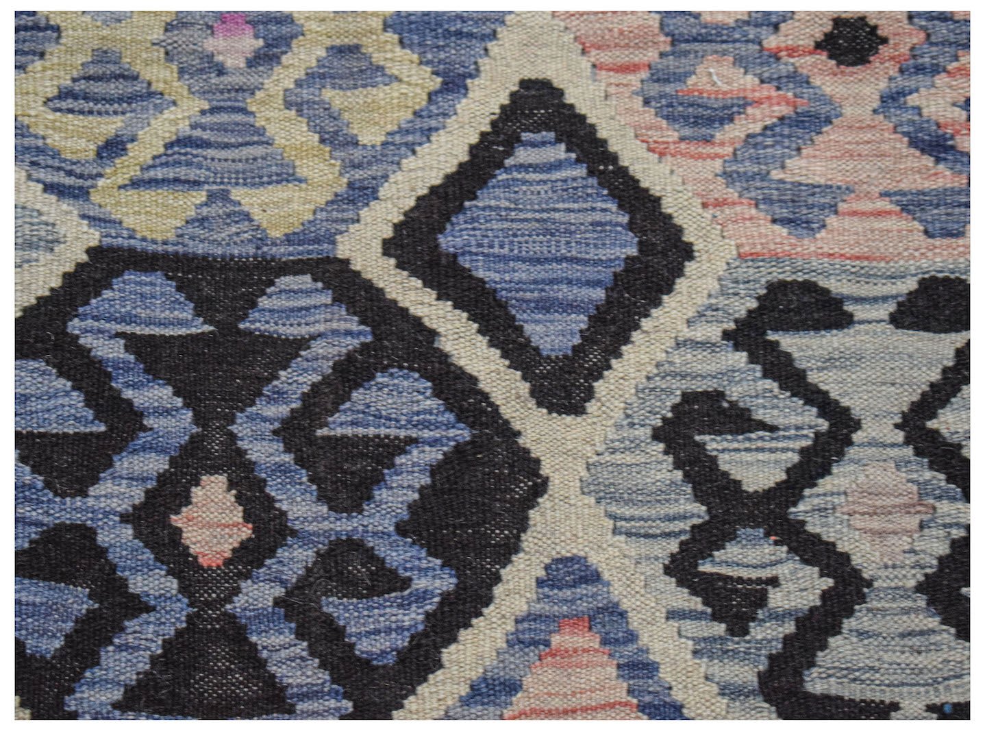 Handwoven Afghan Maimana kilim featuring a geometric pattern in blue, black, and cream tones.