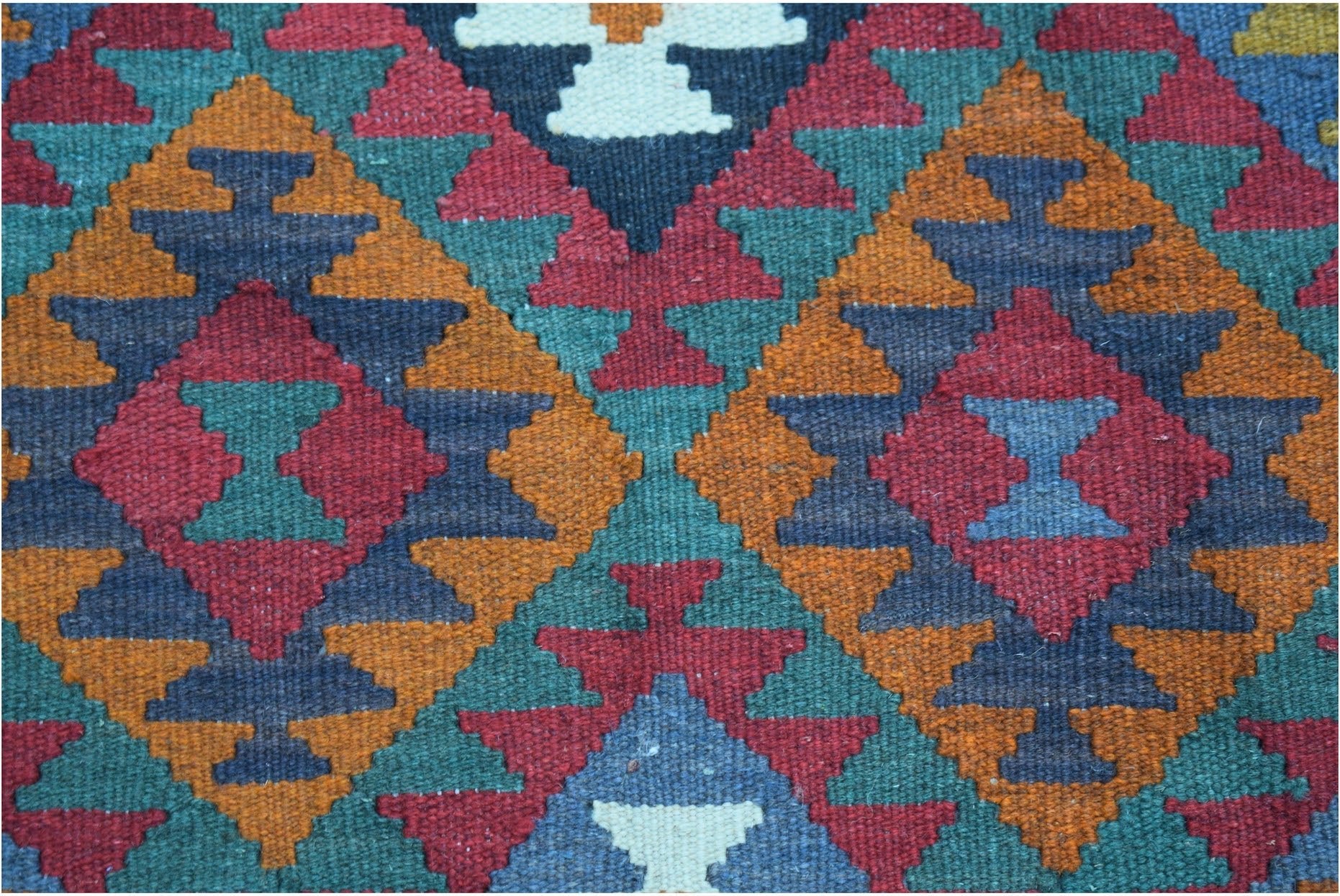 Handwoven Afghan Maimana kilim featuring a geometric pattern in red, orange, blue, and green.